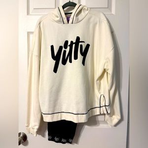 Yitty brand cream hoodie and black leggings